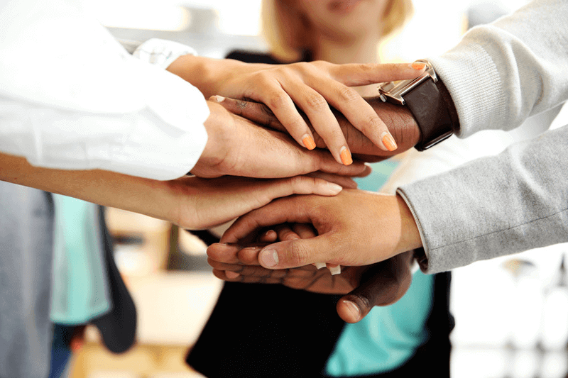 Hands crossed between team members