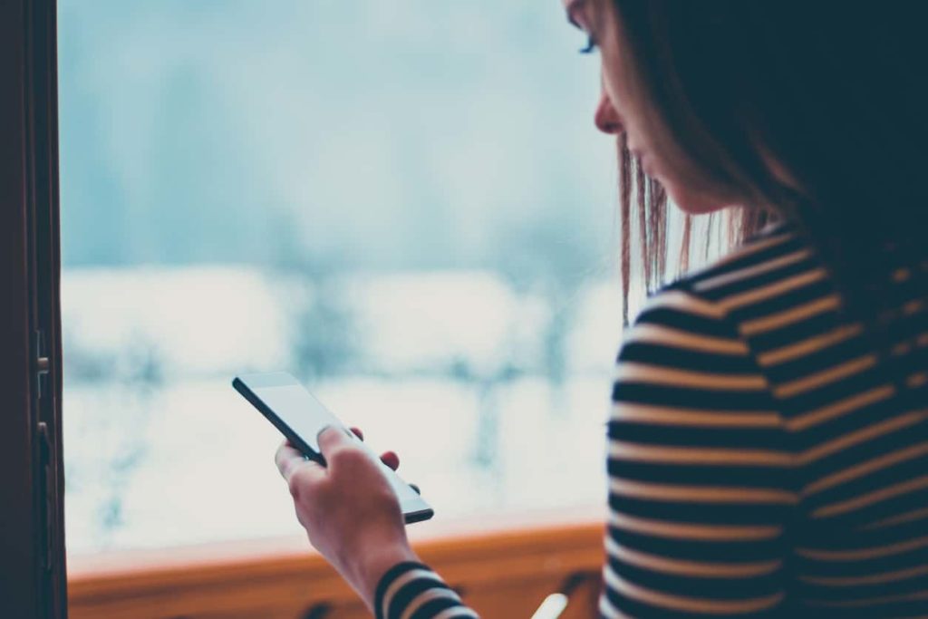 a girl using her smartphone to look up sustainable DCB ecosystem