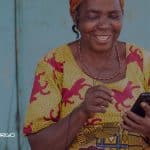 Women in Africa with mobile phone using Music Streaming services