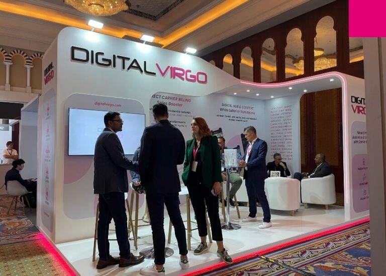 People chat in the Digital Virgo booth at Telecoms World Middle East